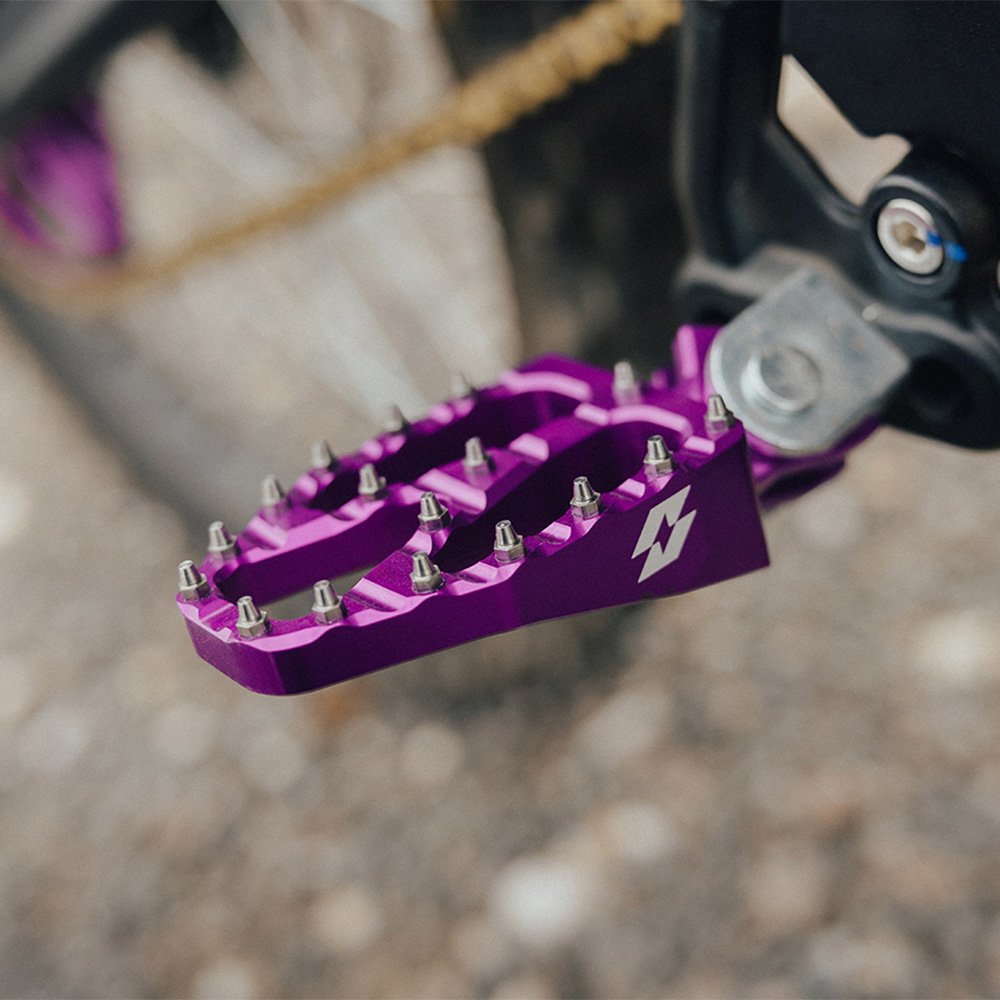 Purple wide footpeg fitted to a bike