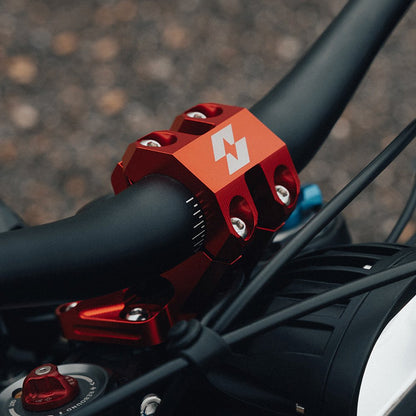 Red 31.8mm handlebar risers, detail view
