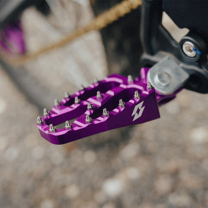 Purple wide footpeg fitted to a bike