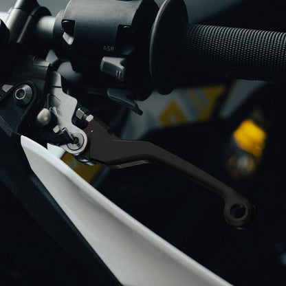 Black adjustable brake levers for Sur-Ron Ultra Bee, fitted to a handlebar