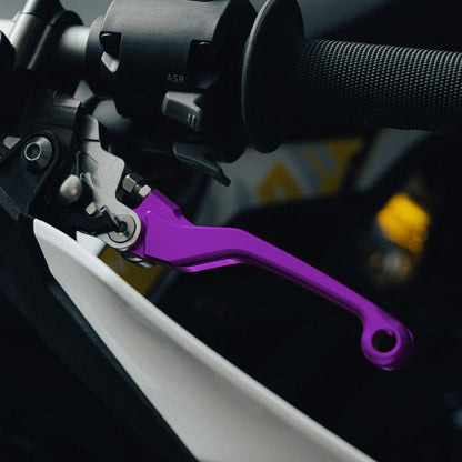 Purple adjustable brake levers for Sur-Ron Ultra Bee, fitted to a handlebar