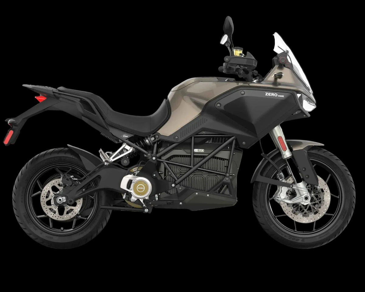 A Zero DS electric motorcycle shown from a side profile view against a solid white background. The motorcycle features a matte black frame, a dark gray and black fuel tank, a black seat, and gold accents on the engine cover.