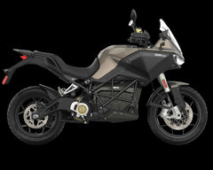 A Zero DS electric motorcycle shown from a side profile view against a solid white background. The motorcycle features a matte black frame, a dark gray and black fuel tank, a black seat, and gold accents on the engine cover.