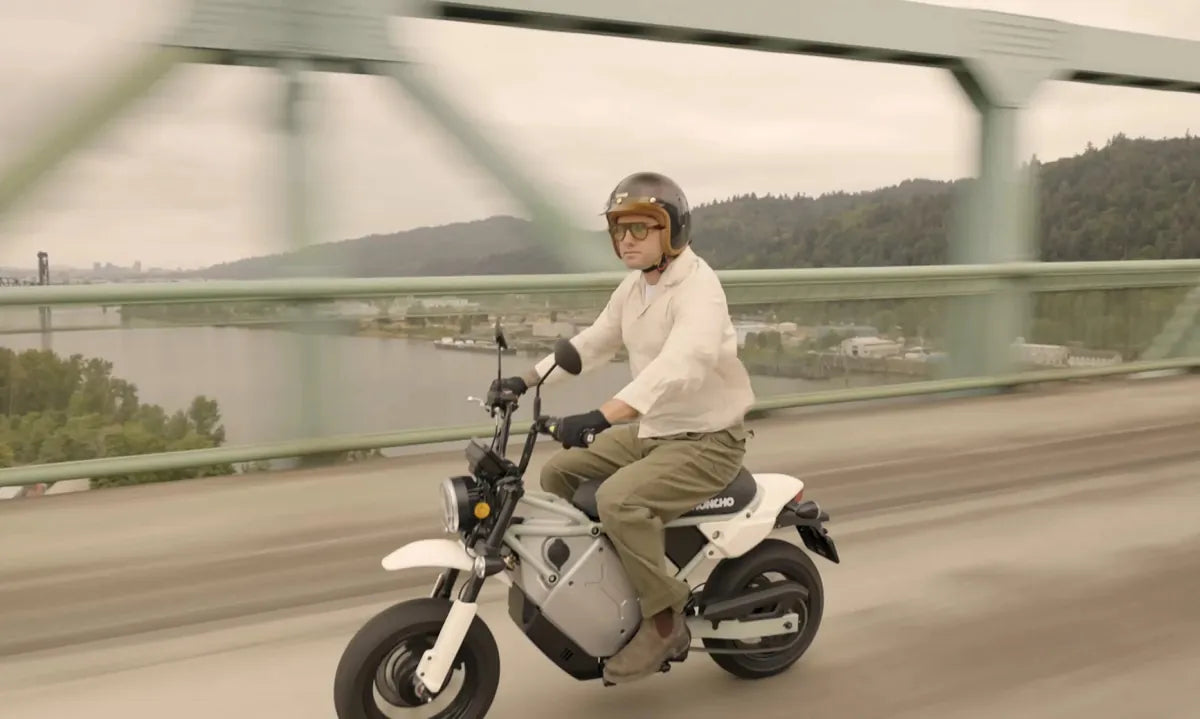 A helmeted rider on a LiveWire S4 Honcho Street crossing a bridge