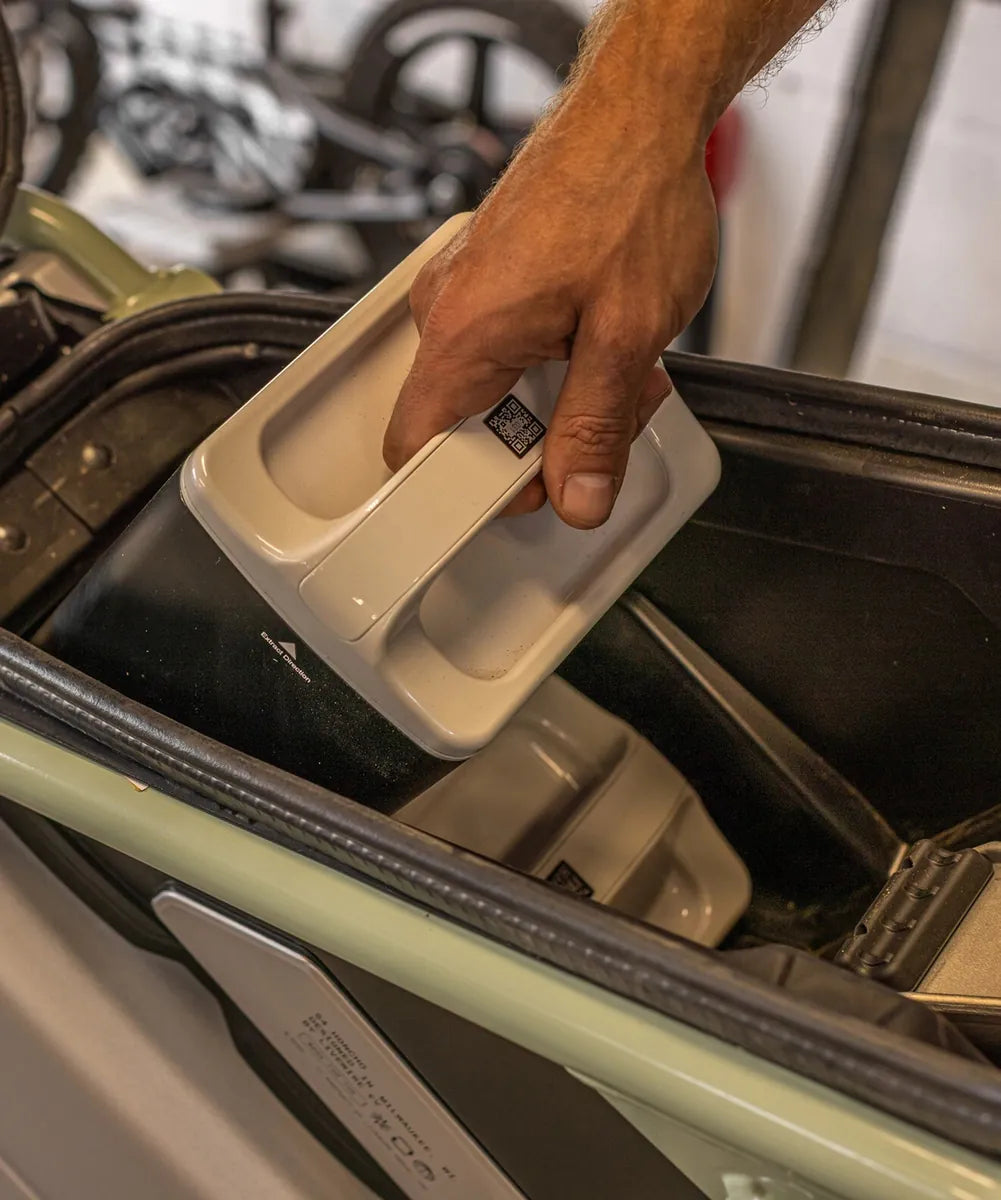 A removable battery being lifted from the LiveWire S4 Honcho Trail battery compartment